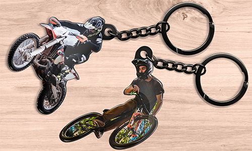 Motorcycle-themed keychains featuring riders in action on dirt bikes